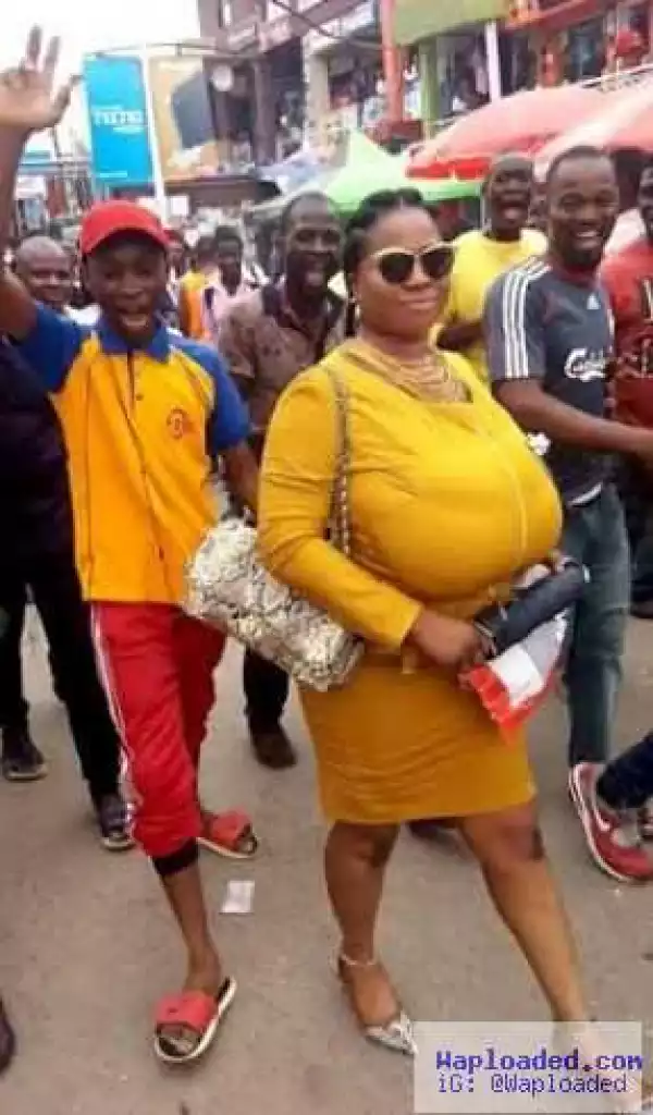 Photos: Big breasted woman followed around by men at Computer Village, Ikeja 